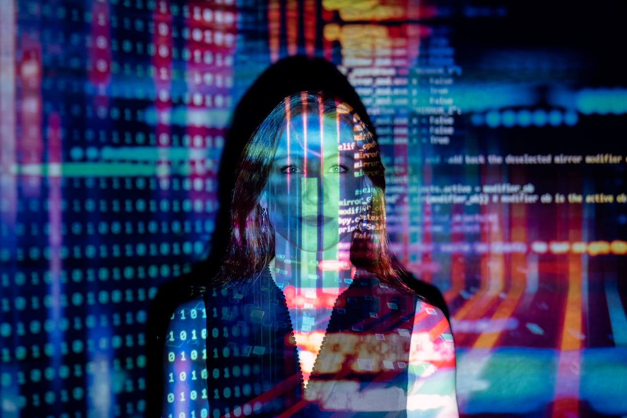 service-04 A woman with digital code projections on her face, representing technology and future concepts.